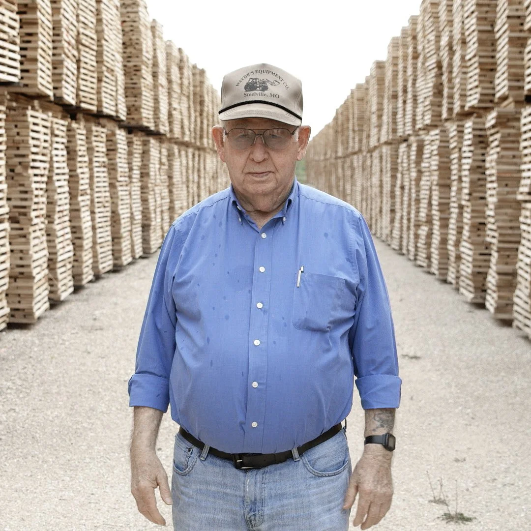 Leroy McGinnis of McGinnis Wood Products standing in their outdoor wood drying lot