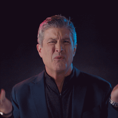 Several people reacting with over the top emotions in a studio enivornment