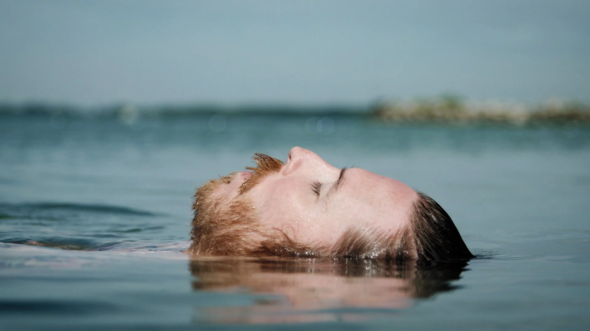 Jonny Coffman floating in a lake