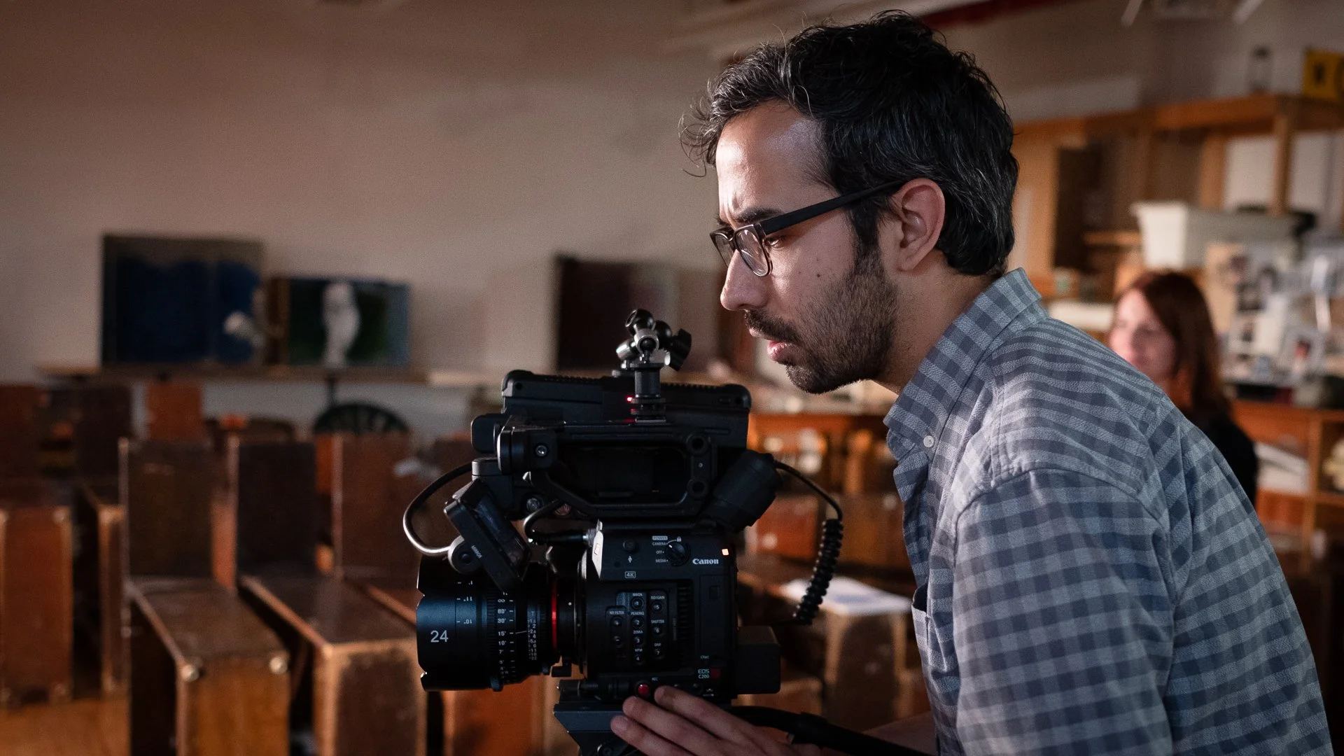 Behind the scenes, cinematographer with his camera during Predictive Behavioral Routing production