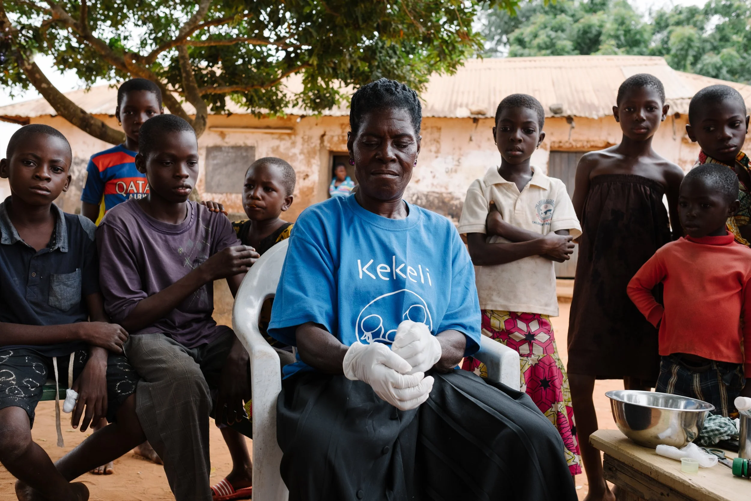 Kekeli Community Health Promoter putting on surgical gloves