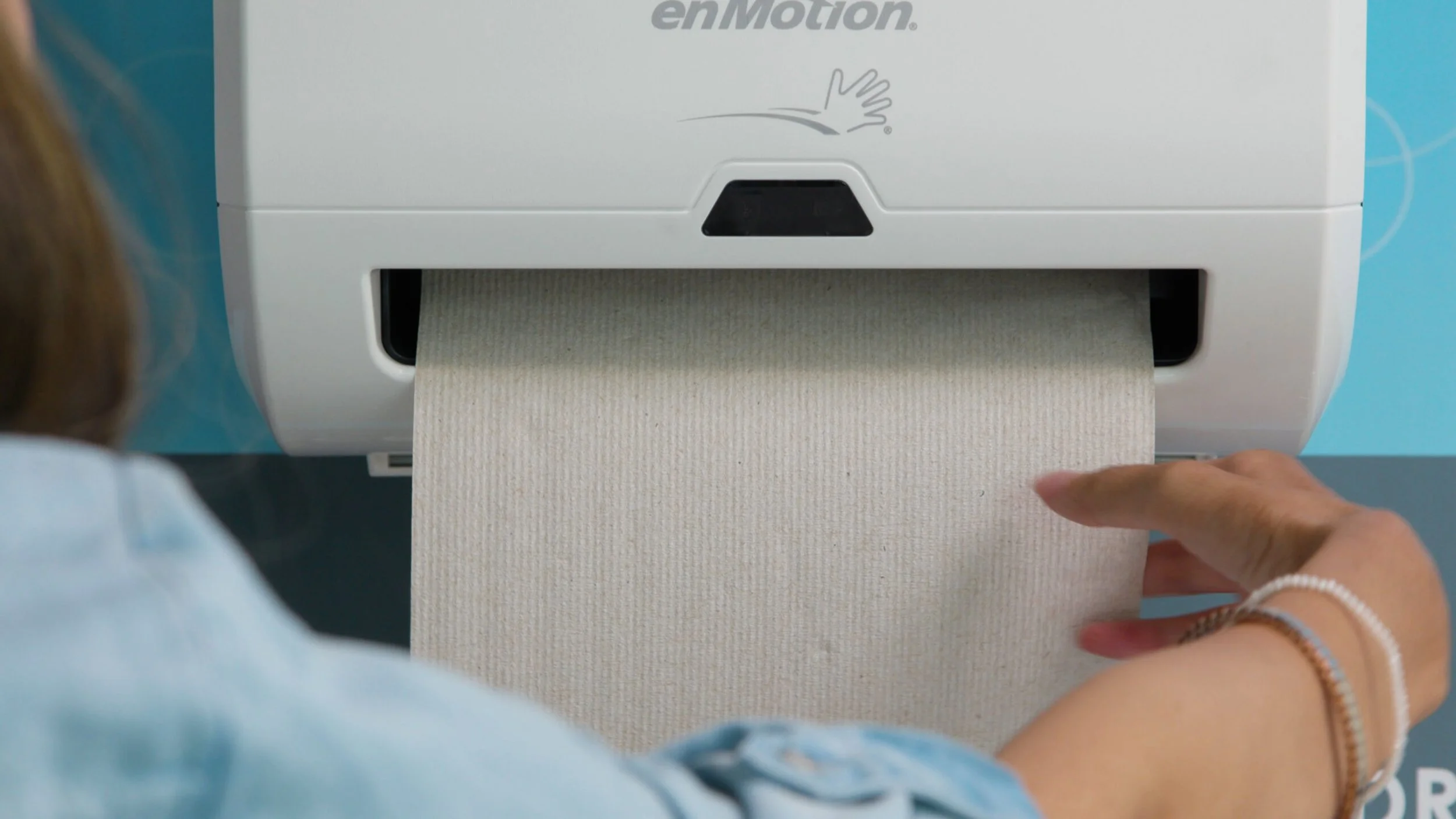 Closeup of paper towel being grabbed from enMotion dispenser