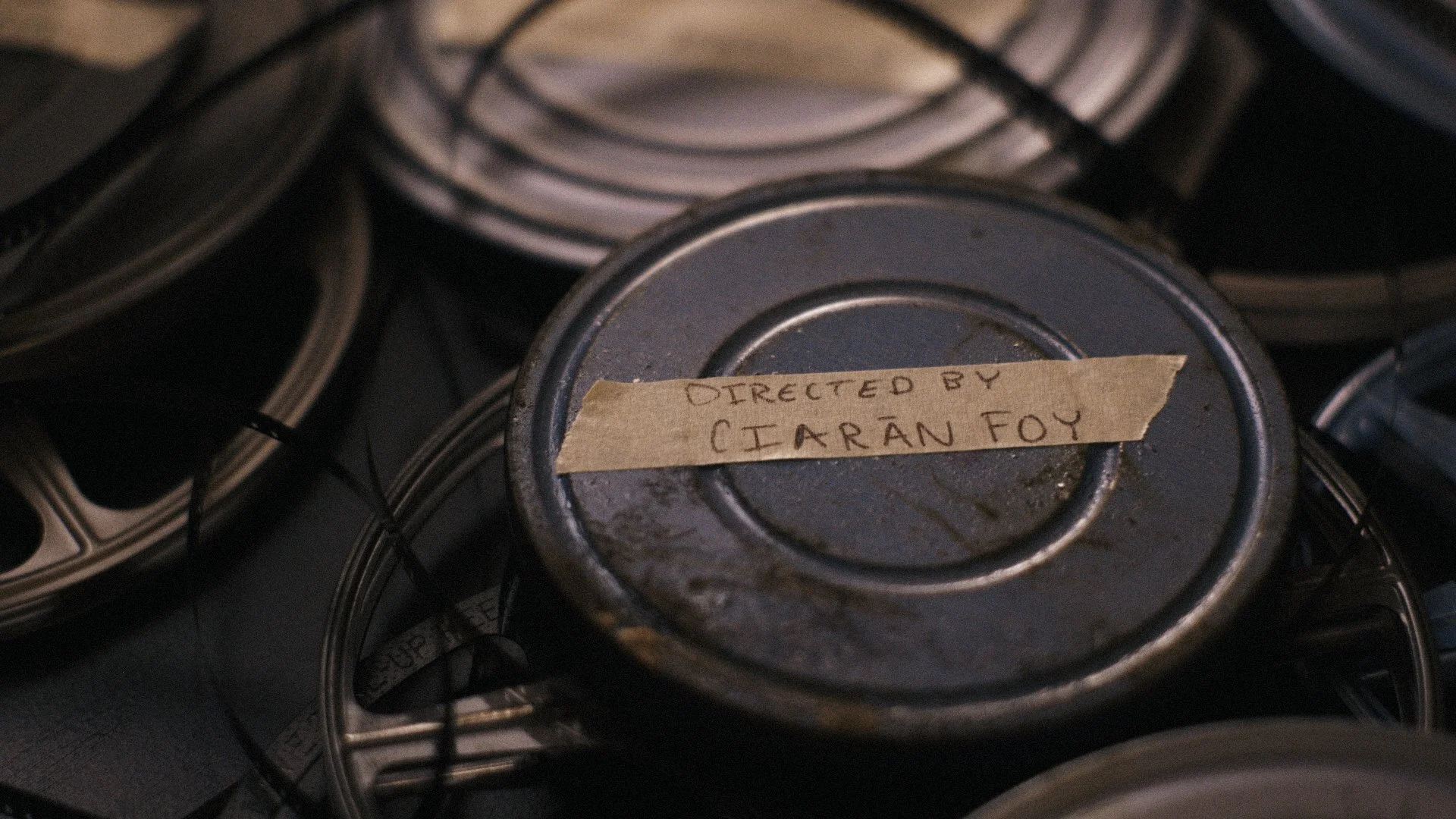 Old film reels scattered on table