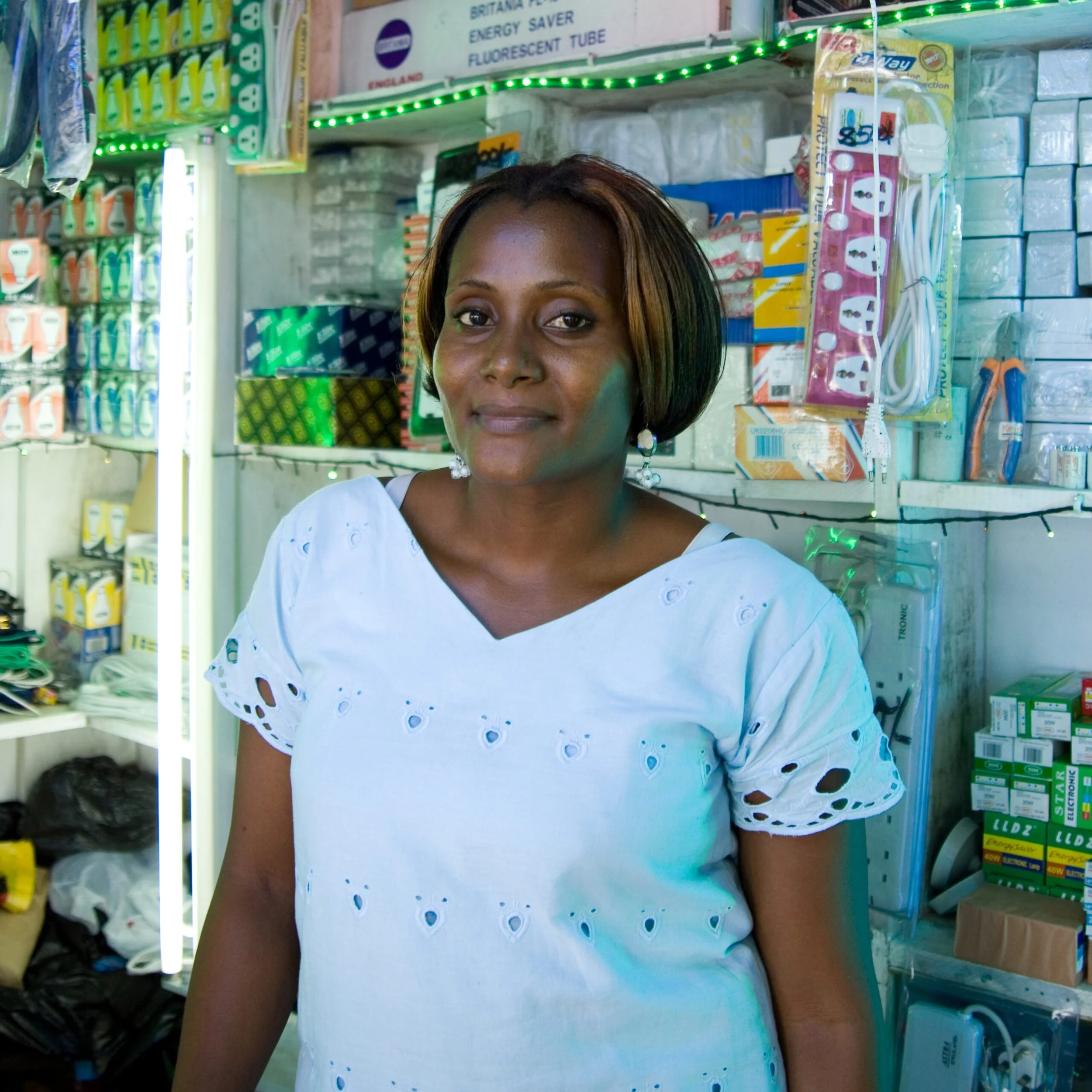 Tanzanian woman standing in her corner store