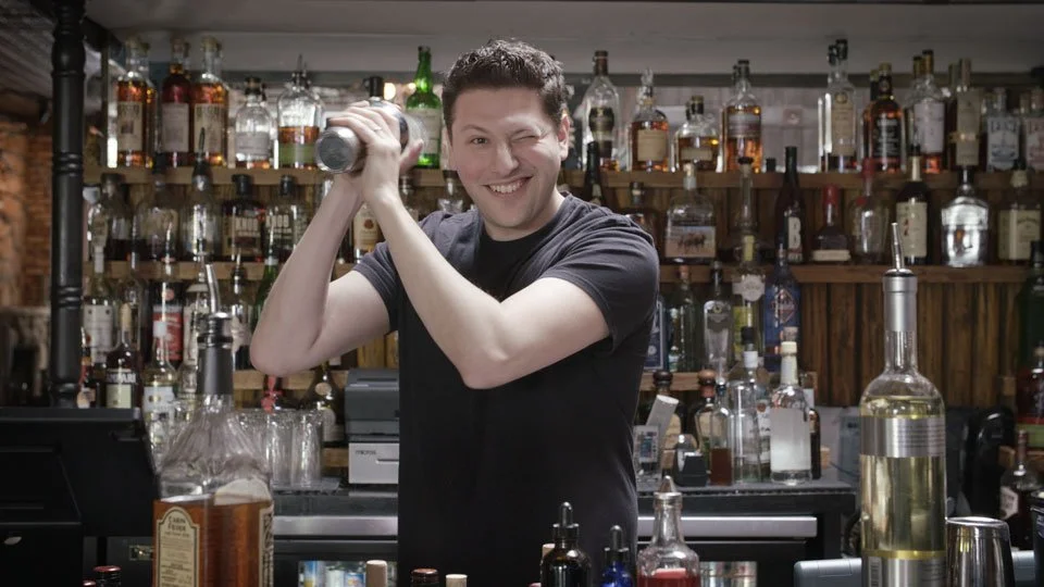 Breadcrumb Pro CEO behind the bar shaking a cocktail shaker