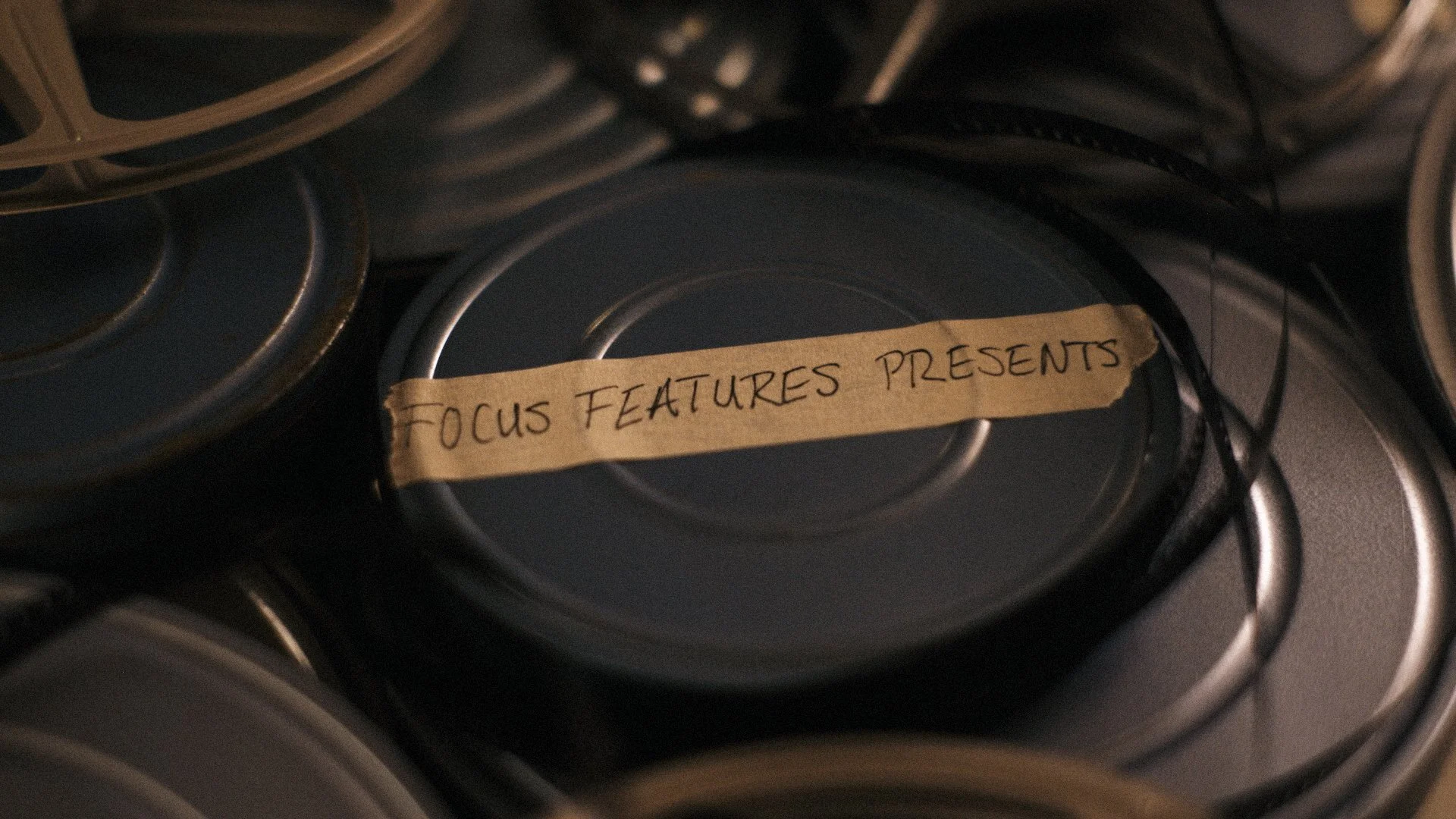 Old film reels scattered on table