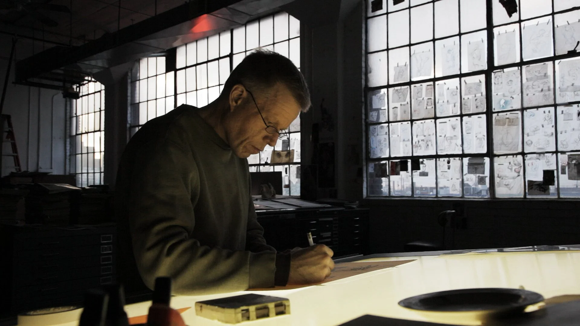 Derek Hess drawing in his studio