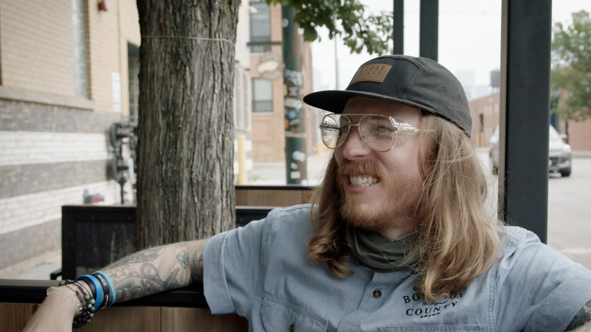 Production still, Jonny Coffman sitting on patio of Goose Island Taproom