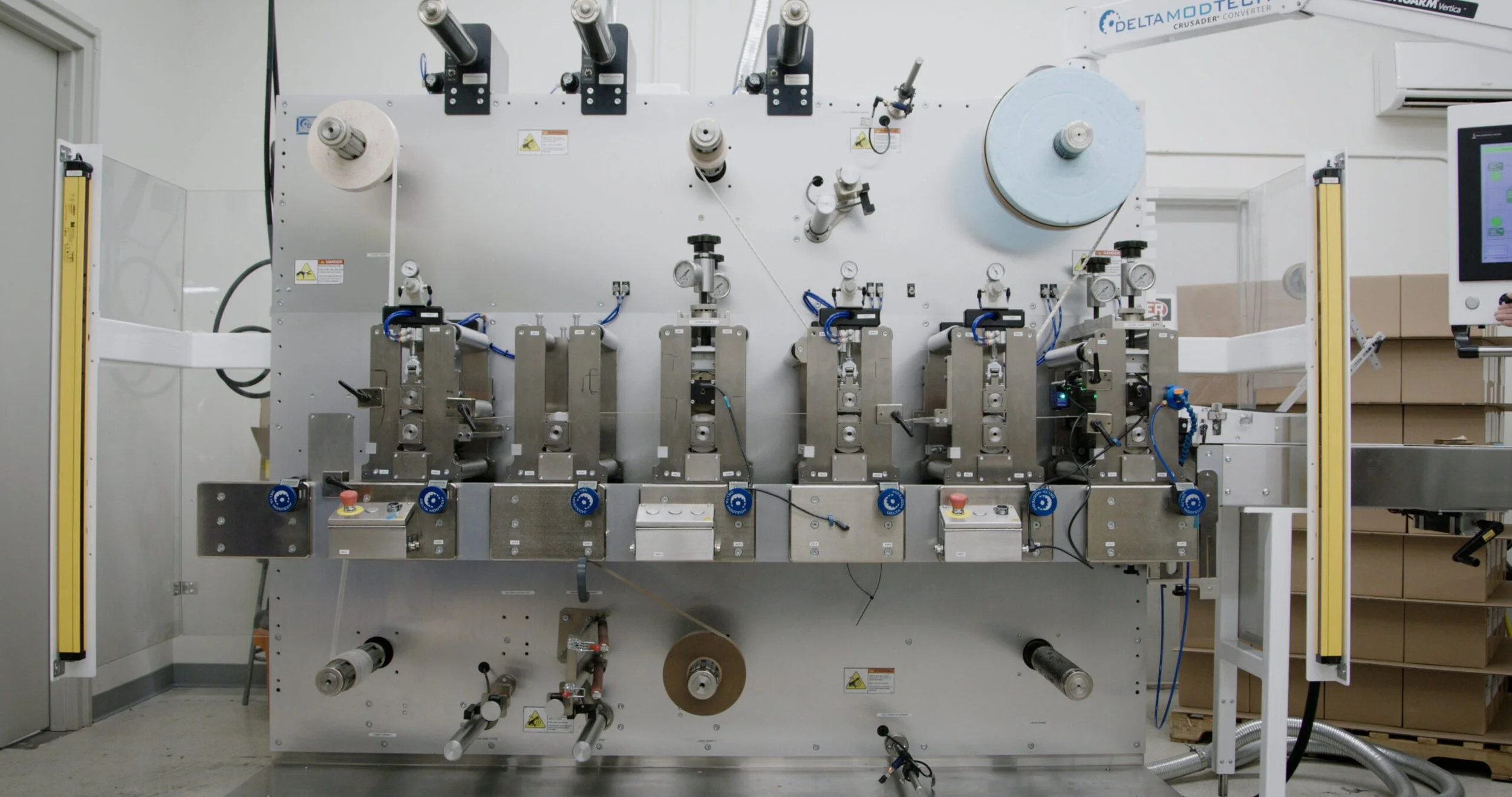 Production still, adhesives tape machine putting it together