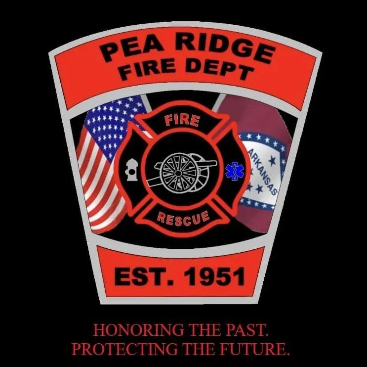 Emblem of Pea Ridge Fire Department featuring the fire rescue badge, American flag, Arkansas state flag, and a fire hose reel, with text indicating establishment in 1951 and a motto about honoring the past and protecting the future.