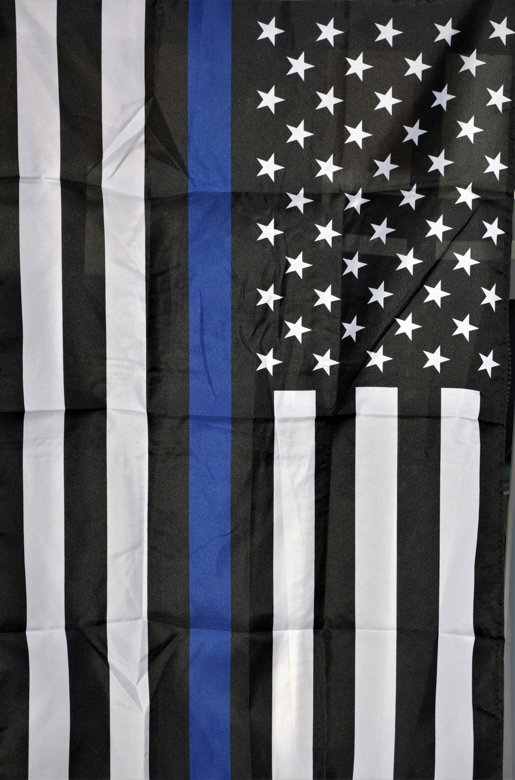 A blue strip Police flag hung vertically.