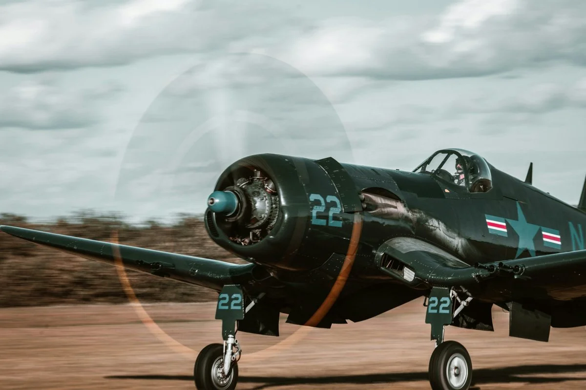 A historic, green plane getting ready for take off.