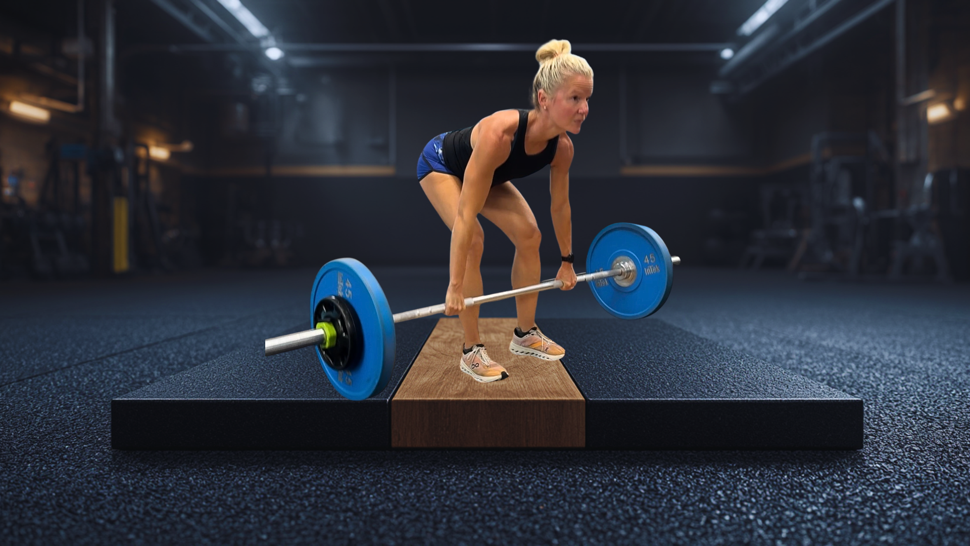 Female strength coach deadlifting in gym specializing in menopause and perimenopause fitness.