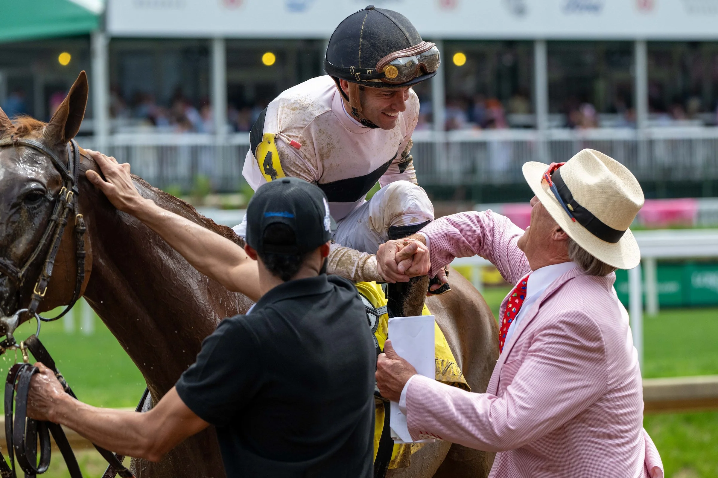 Owner and jockey celebrating after a race at the track