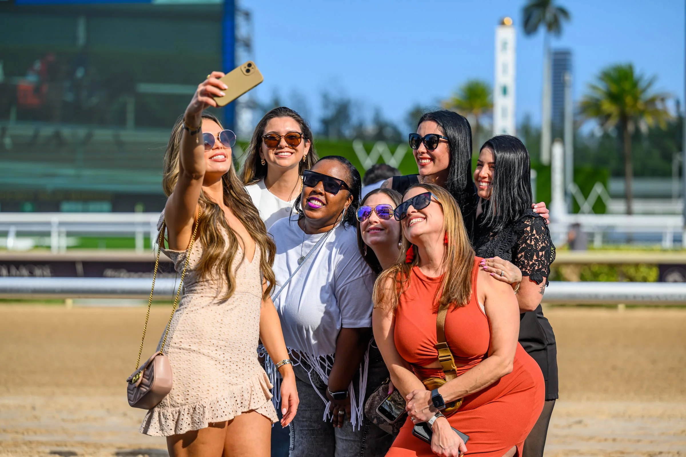 Friends taking a selfie at the racetrack during a day at the races