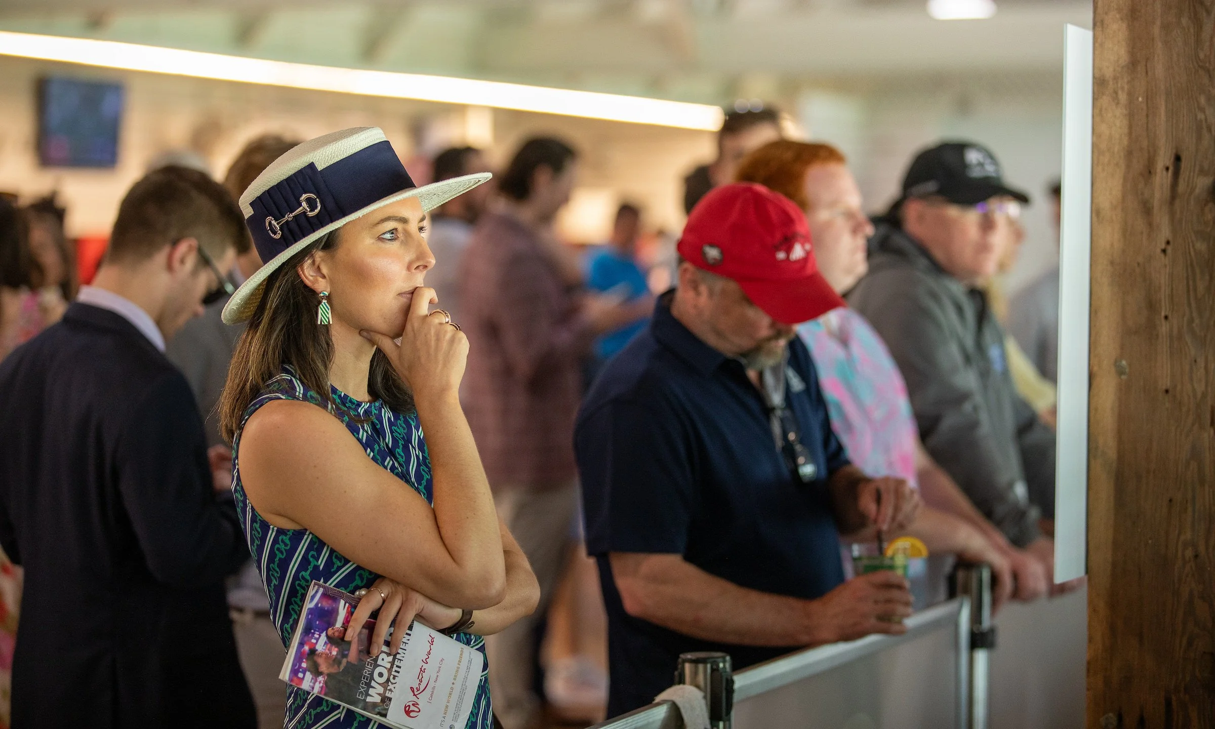 Racehorse owner watching intently from the trackside, capturing the anticipation and emotional investment of ownership