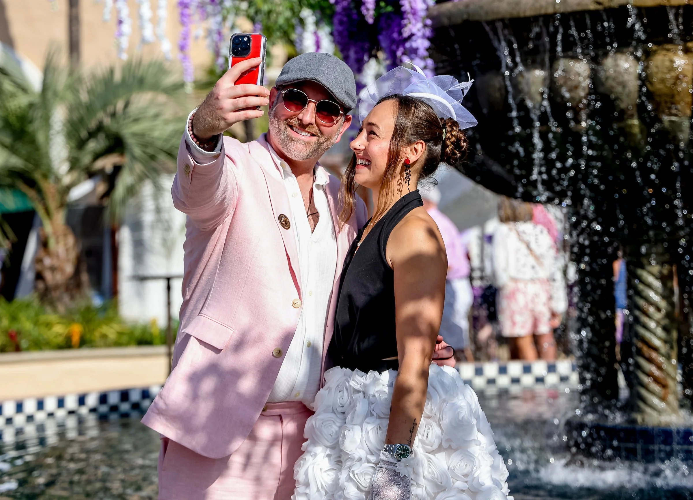 Racehorse owners taking a selfie at the racetrack, highlighting the lifestyle and personal experience of full ownership