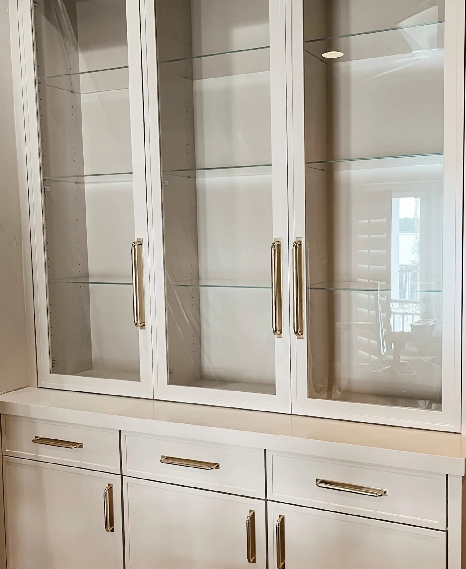 Custom doesn&rsquo;t have to mean overdone. Simple lines, glass fronts, aged brass pulls, and beautifully crafted custom cabinetry create a built-in that feels timeless and intentional. Almost ready for styling ✨