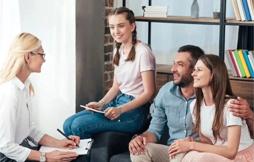 Student and Family Sitting with College Counselor