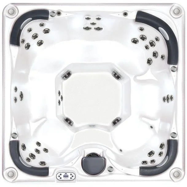 Top view of a white hot tub with multiple jets, black headrests, and control panel.