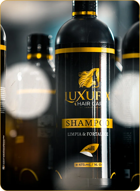 Black and yellow bottle of Luxurx shampoo for hair care, with a stylized woman's hair on the label, surrounded by similar bottles on a store shelf.