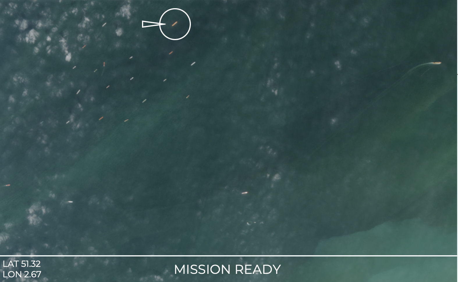 Aerial view of a boat in the water with a missile flying nearby, with ocean and land in the background, displaying coordinates LAT 51.32 LON 2.67 and the text 'MISSION READY'.