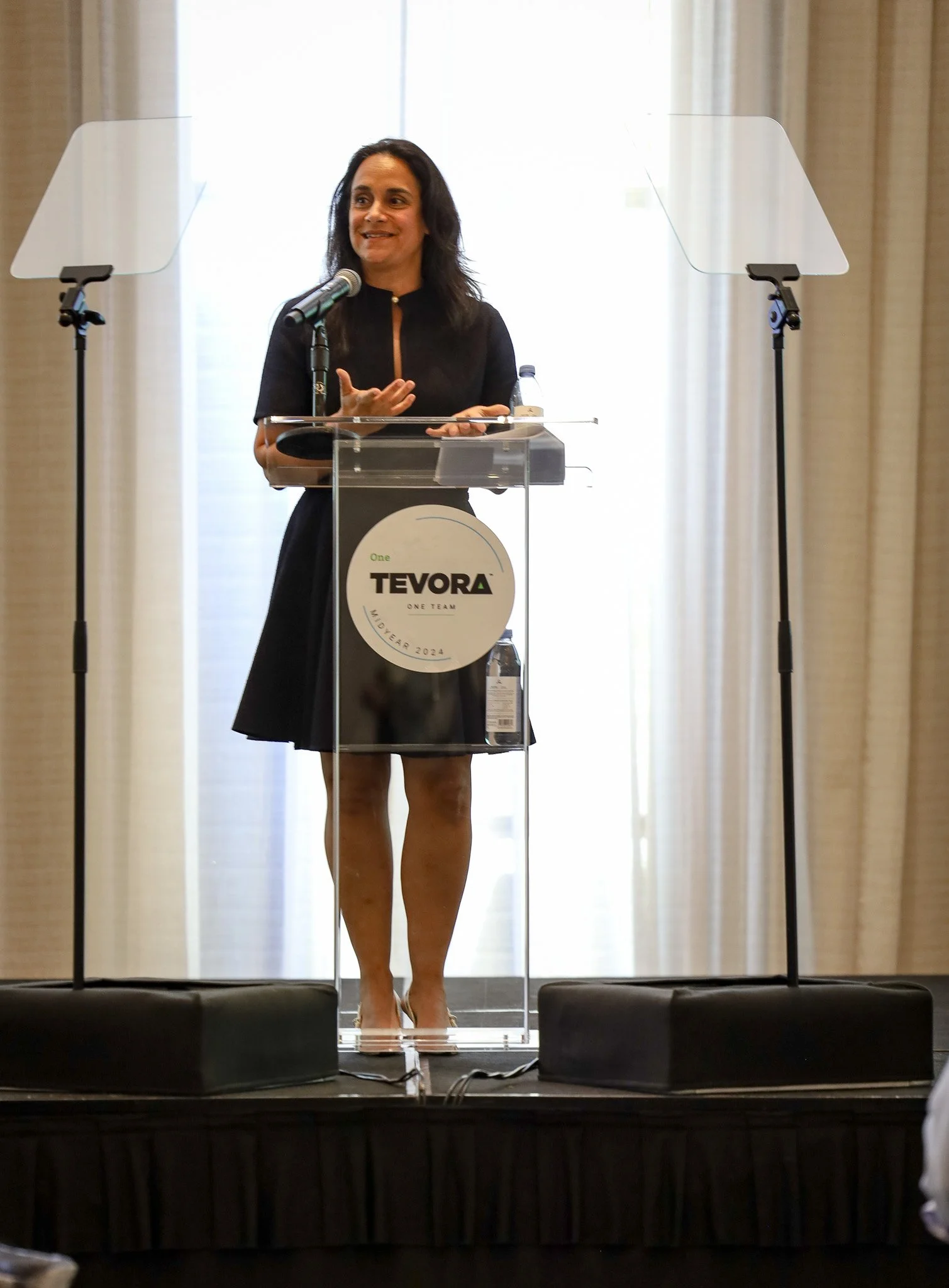 Nazy Fouladirad, Cybersecurity Operations leader, giving a speech at a podium during an event.