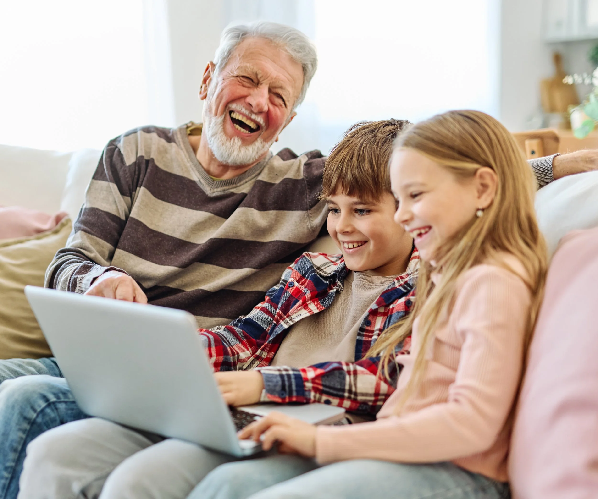 grandfather-with-children-laughing-using-laptop-co-2026-09-22-11-22-27-utc.jpg