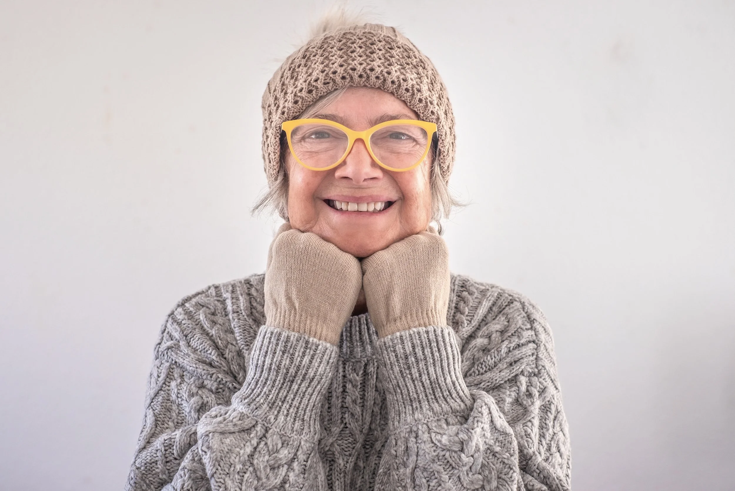 smiling-senior-woman-with-beanie-and-yellow-glasse-2026-09-22-19-25-04-utc.jpg
