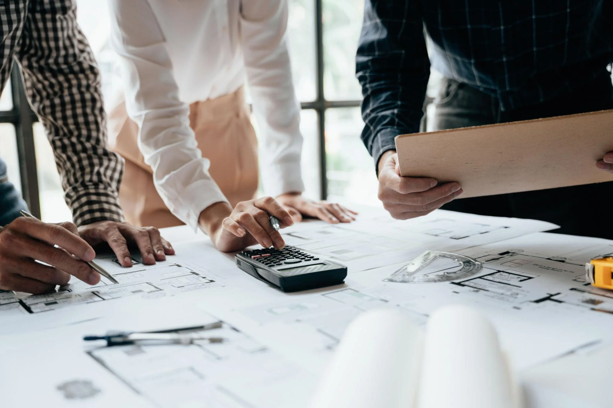 Reviewing construction plans and calculating job costs for accurate financial management in a construction business in North Carolina