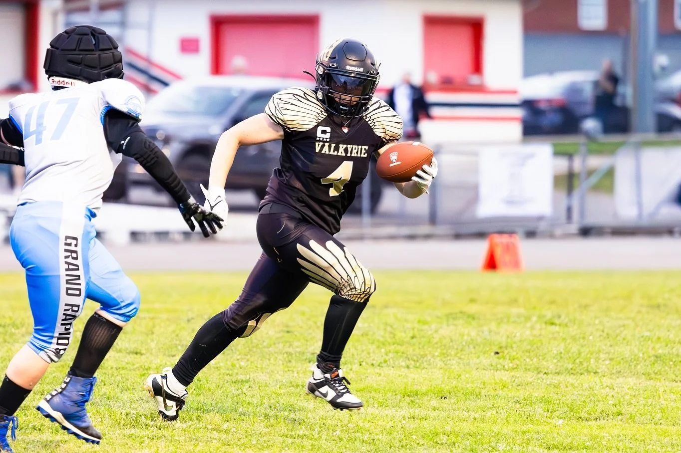 Young woman athlete during a tackle football match.