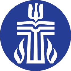 A blue circular logo featuring a stylized white emblem with symmetrical design elements, including a central cross-like shape with flame or leaf motifs at the bottom.