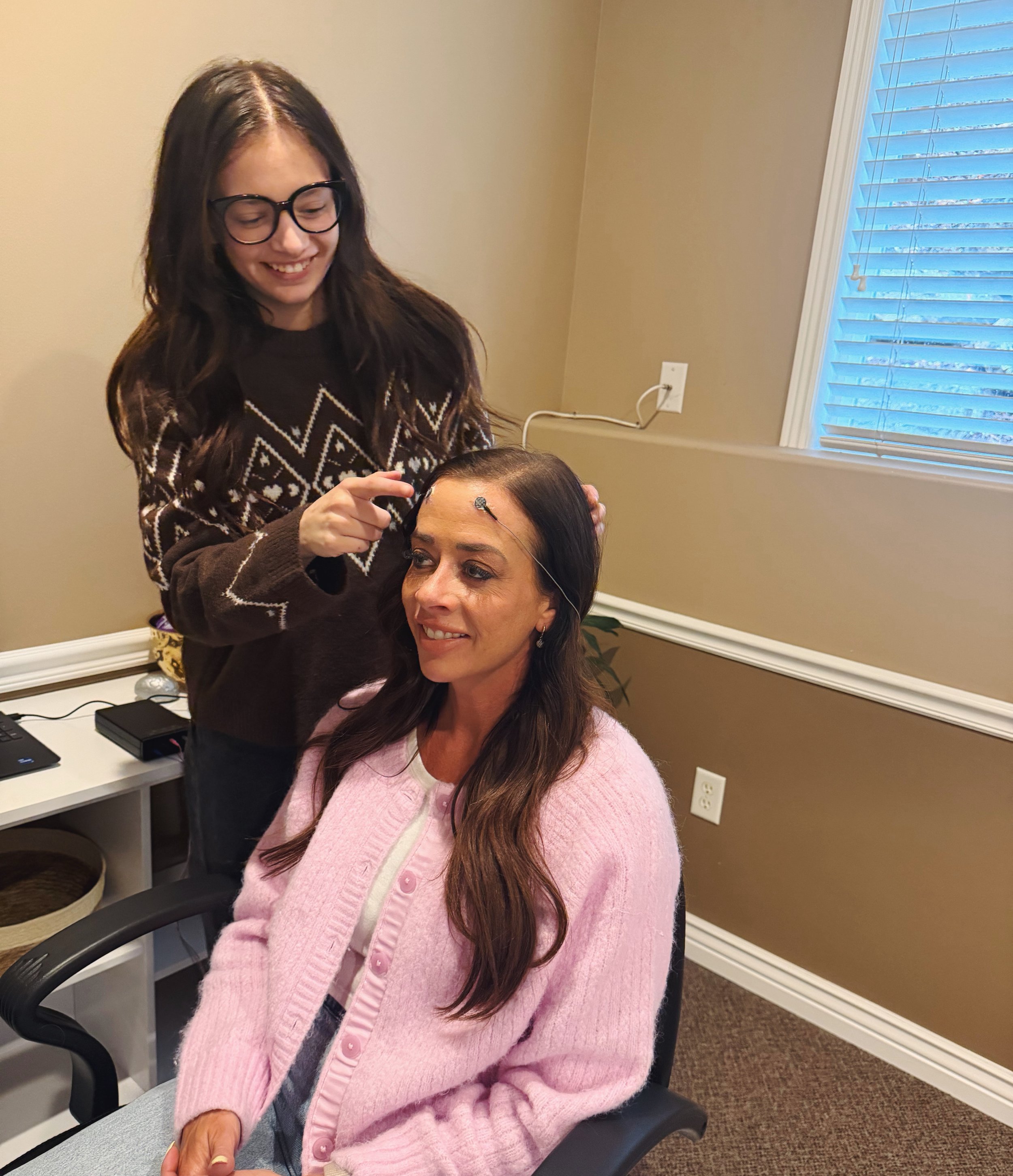Girl performing microcurrent feedback on patient