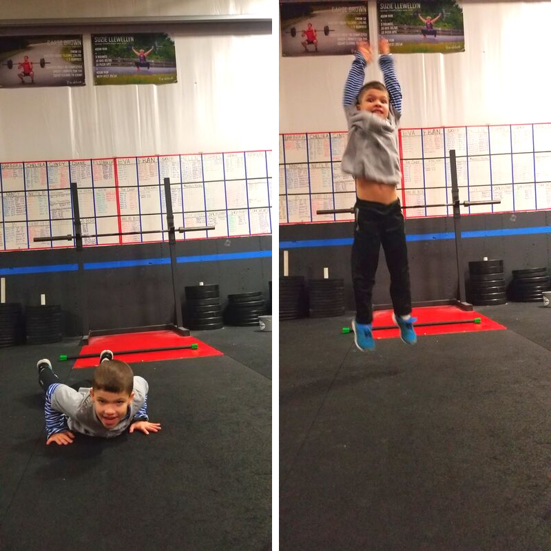 A young boy doing push-ups on the gym floor and then jumping in the air at a fitness center.