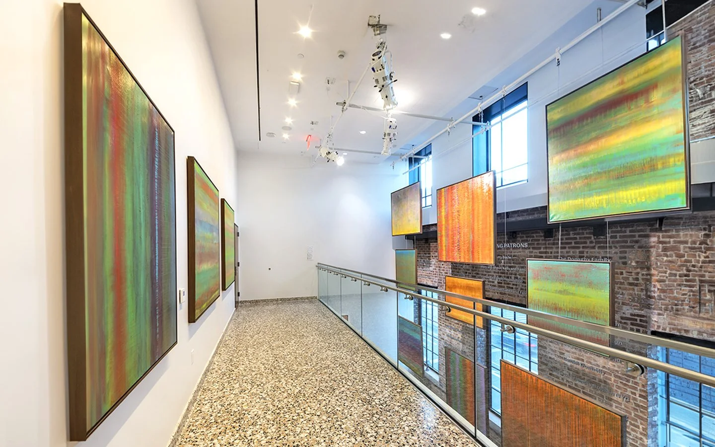 Installation view of Paul Hughes exhibition featuring large abstract colour field paintings in gallery space with suspended works and mezzanine walkway