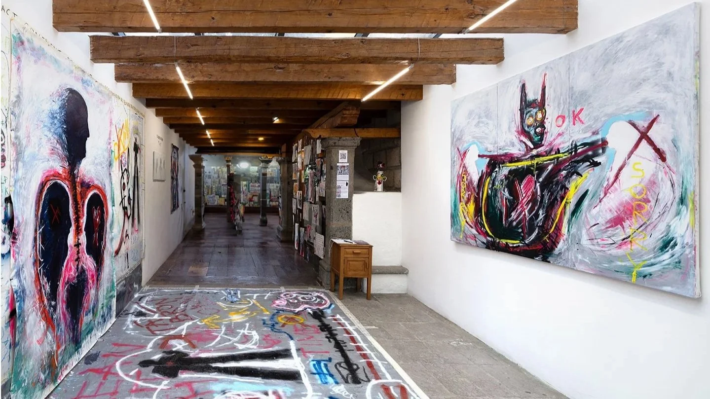 Installation view of “Tá Brón Orm” by PIGSY at Casa Lü, Mexico City, featuring immersive corridor with large-scale figurative paintings, floor work and text-based elements