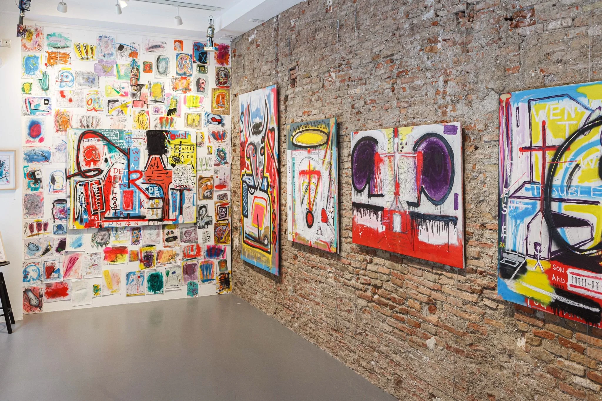 Wide installation view of PIGSY exhibition showing combination of large paintings and small works on paper, La Casa Amarilla Malaga