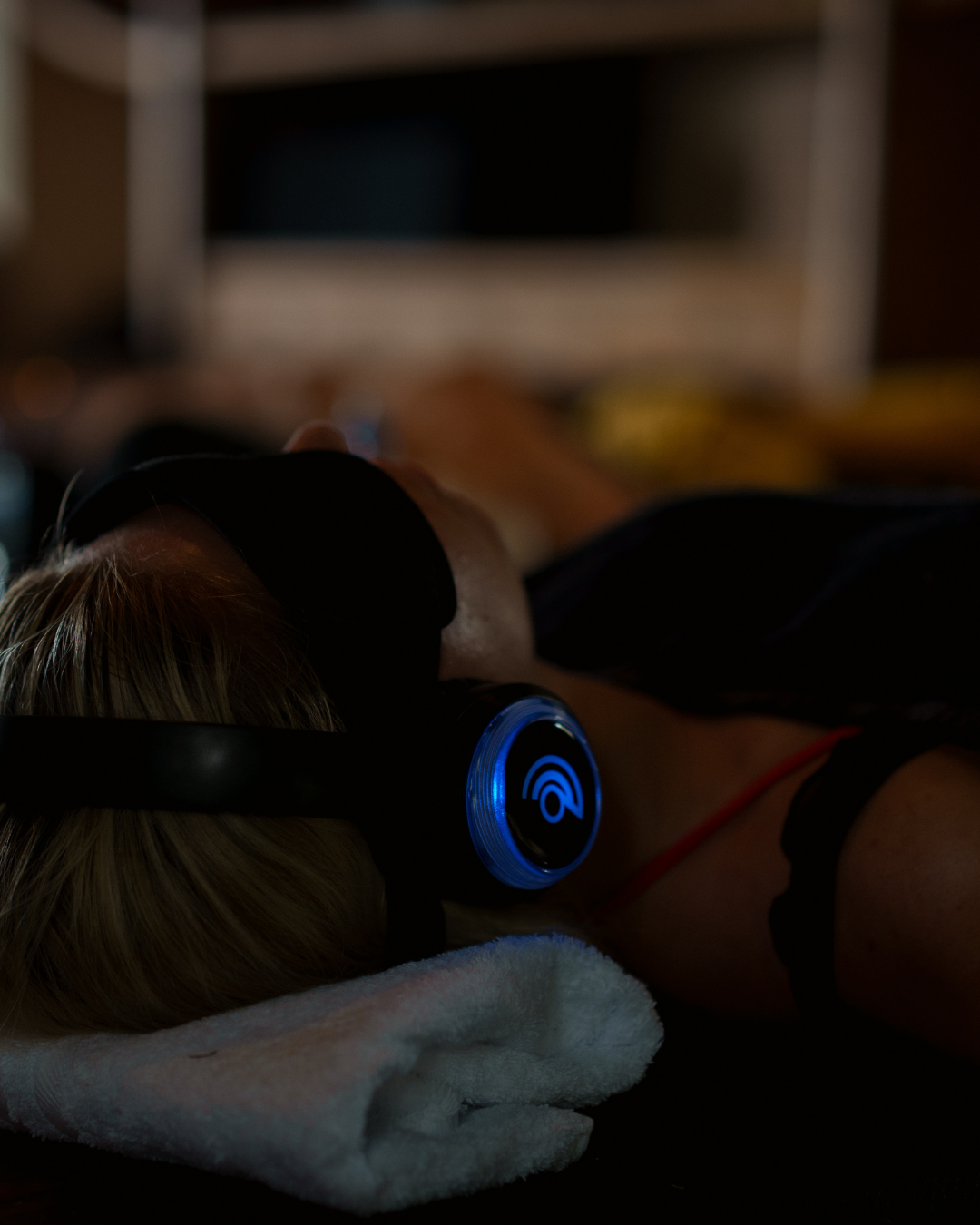 Close-up of a participant using 9D Breathwork headphones for a multi-dimensional somatic healing session in Hamilton, NZ.