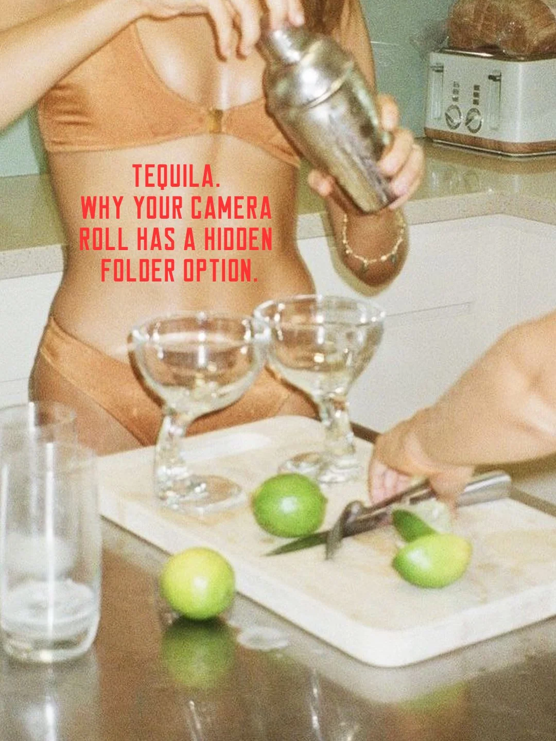 A woman in a tan outfit is pouring alcohol into cocktail glasses on a kitchen counter. Cut limes are on a cutting board with a knife. A person to the right is preparing a drink, and there are glasses and a lime on the counter. The text overlay reads, 'Tequila. Why your camera roll has a hidden folder option.'