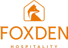 The Foxden Hospitality logo featuring an orange fox silhouette inside a hexagon, with the words 'FOXDEN HOSPITALITY' below in orange text.