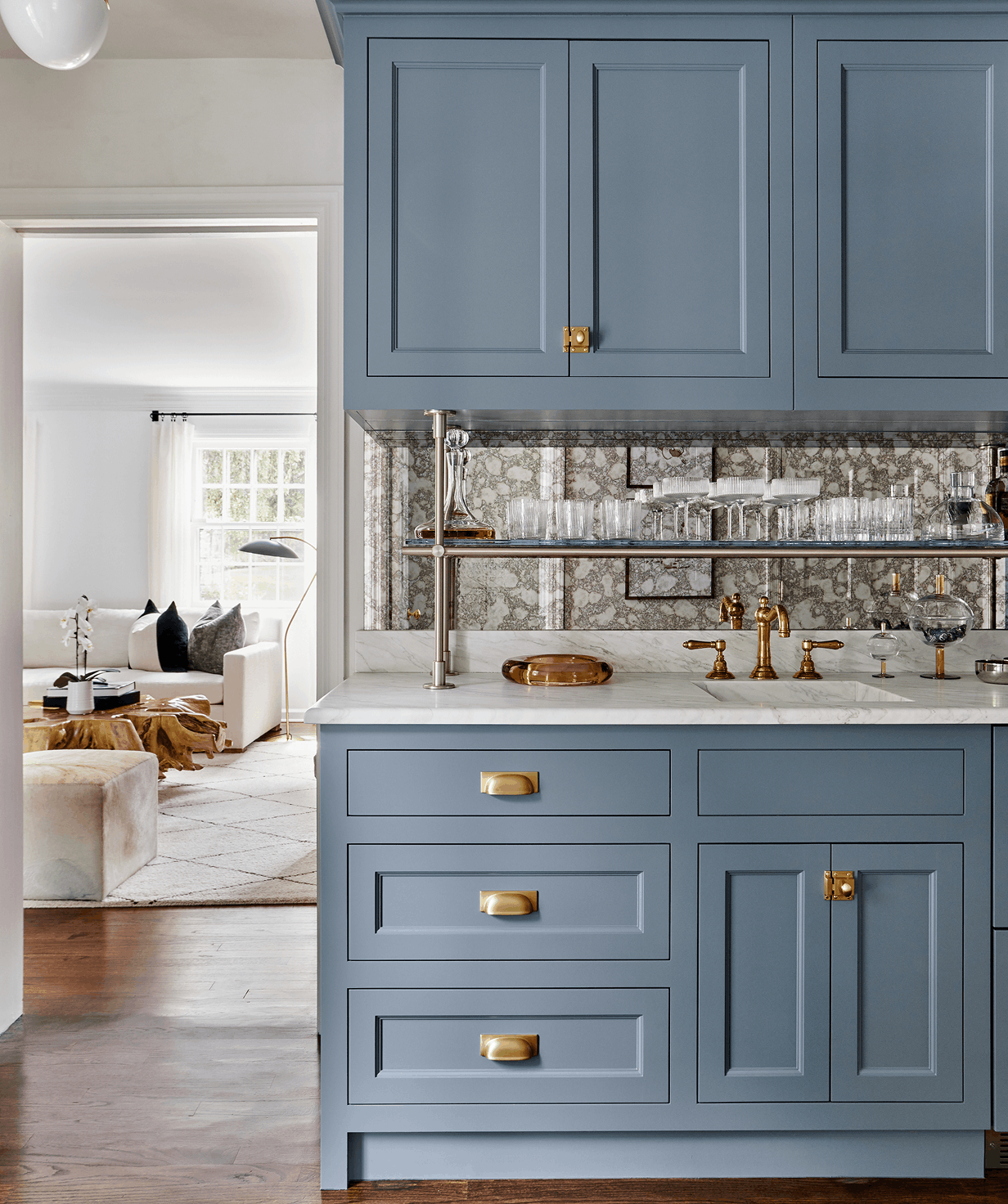 blue cabinets with gold finishings in a custom kitchen by an interior designer