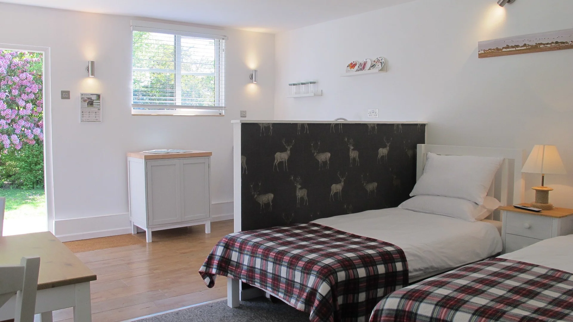 Cozy bedroom interior of a New Forest self-catering holiday cabin with twin beds.