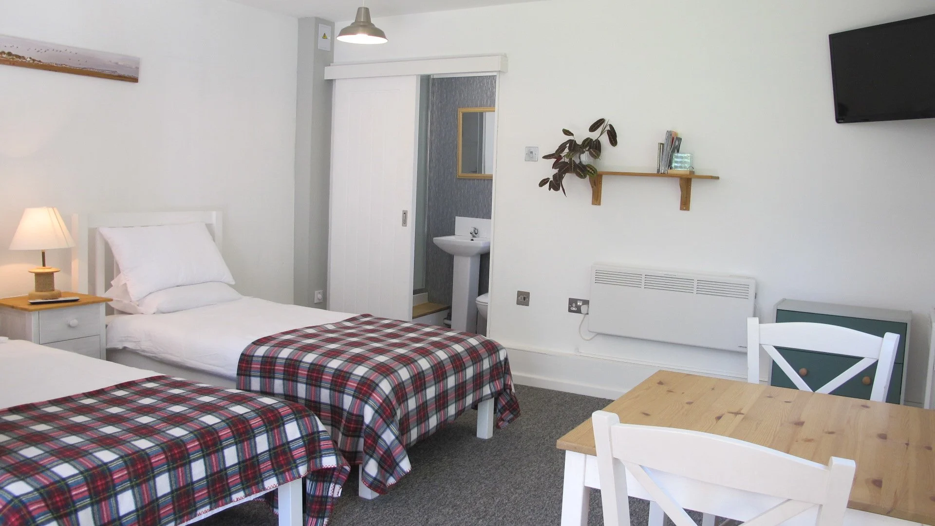 Cozy bedroom interior of a New Forest self-catering holiday cabin with twin beds.