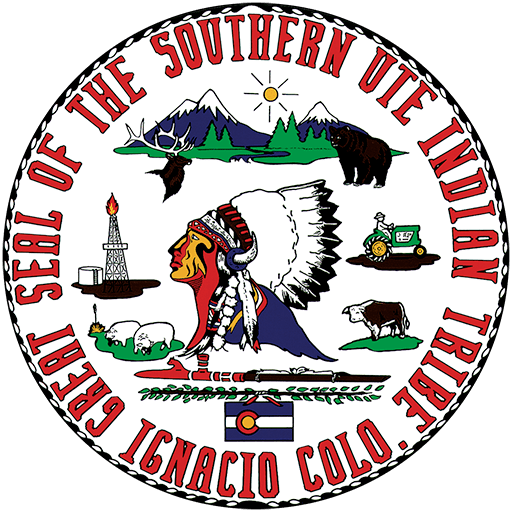 Seal of the Southern Ute Indian Tribe featuring a Native American chief, mountains, a sun, a bear, an eagle, a tractor, a buffalo, a torch, and the Colorado River with the Colorado state flag at the bottom.