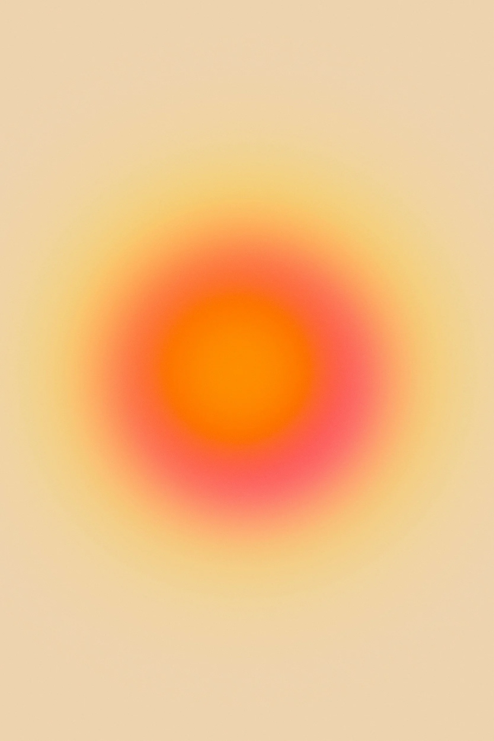 Blurry abstract image with a gradient of warm colors, featuring a reddish-orange center fading into yellowish surrounding areas.