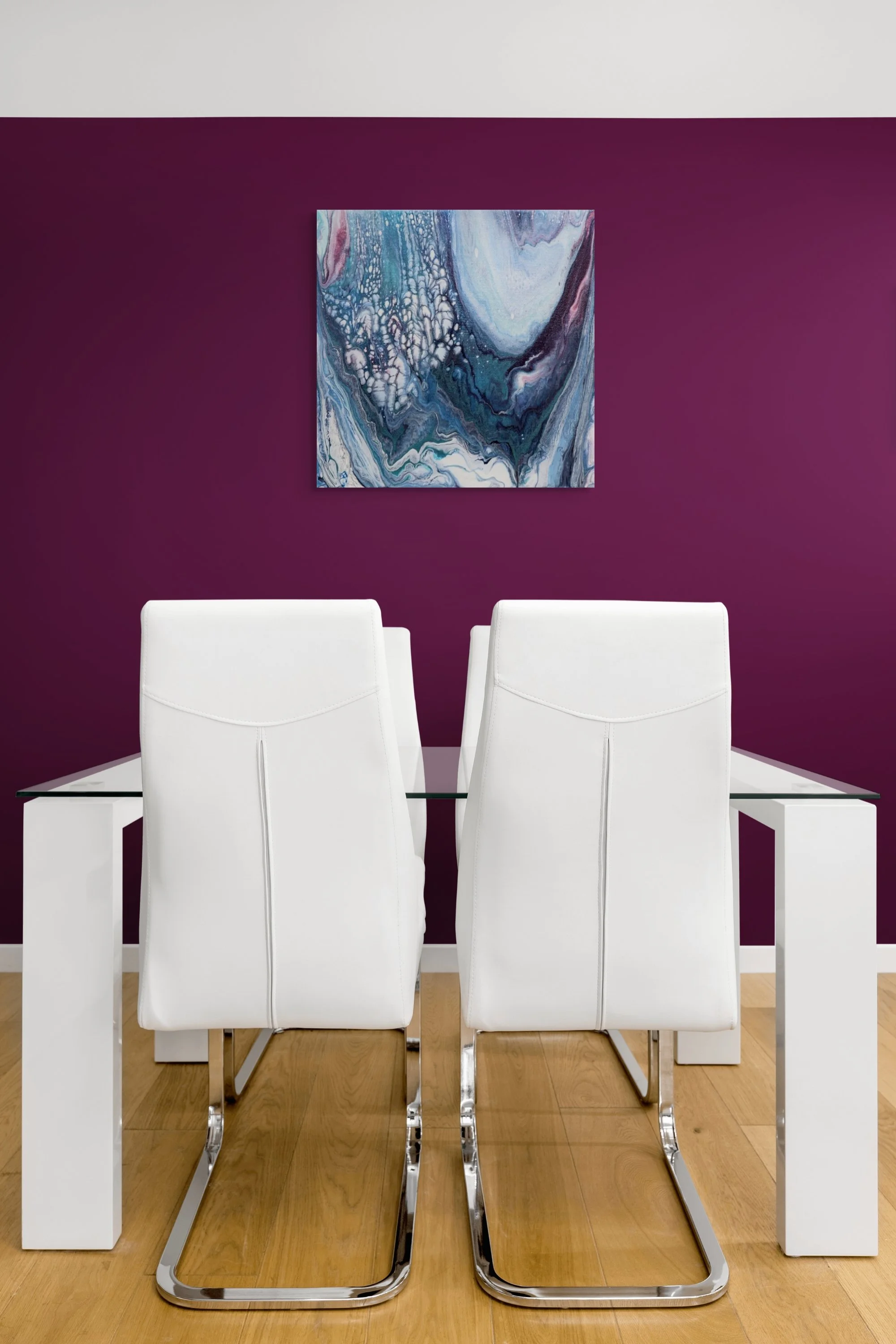 A modern dining room with a purple accent wall, white dining chairs, and a glass-top table. A colorful abstract painting hangs on the purple wall, and the floor is made of light wood.