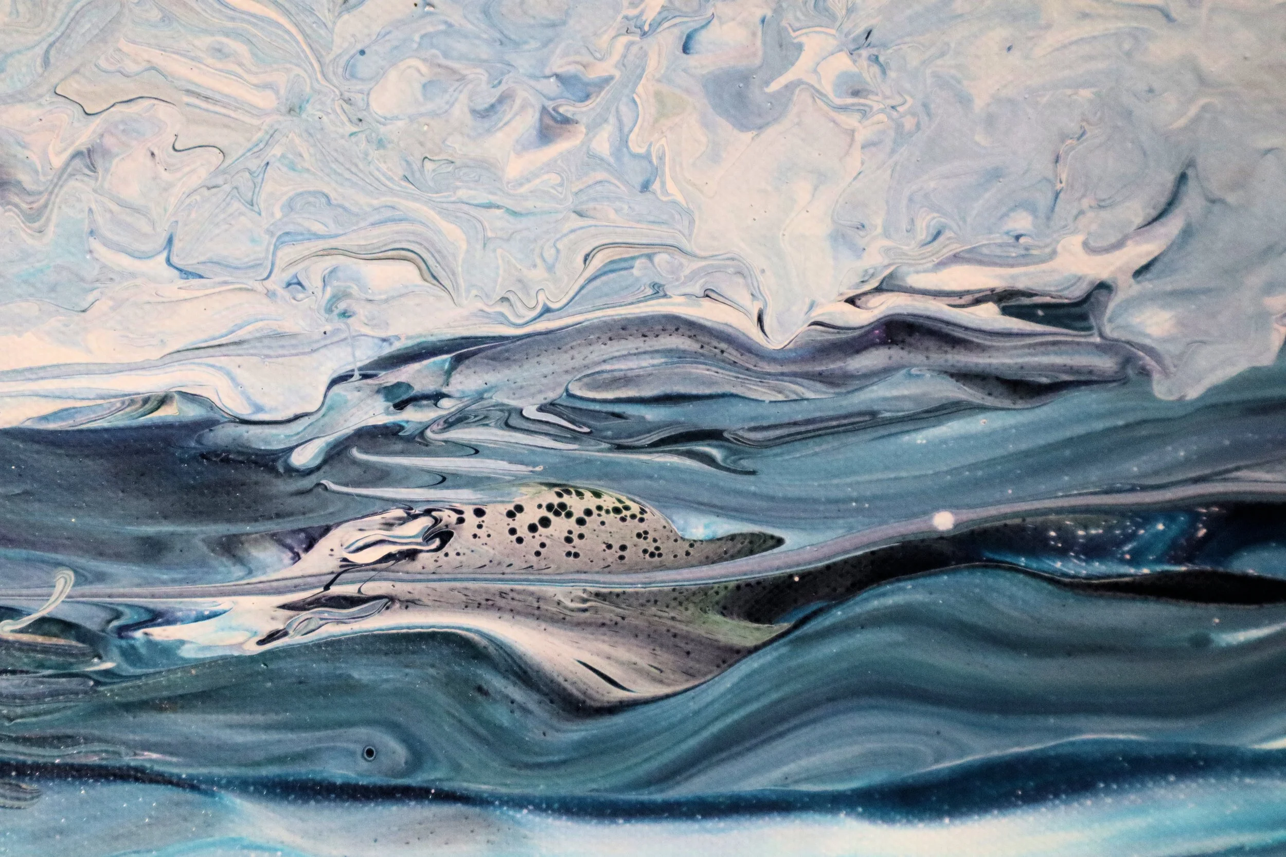 Abstract painting with swirling shades of blue, white, black, and hints of pink and purple.