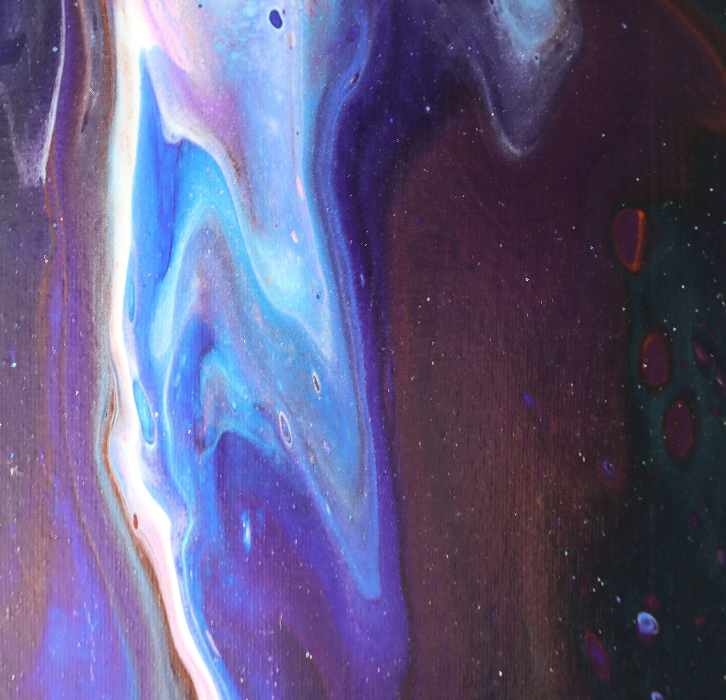 Close-up of a colorful, abstract painting with swirling patterns in shades of blue, purple, pink, orange, and black, with small bright dots resembling stars.
