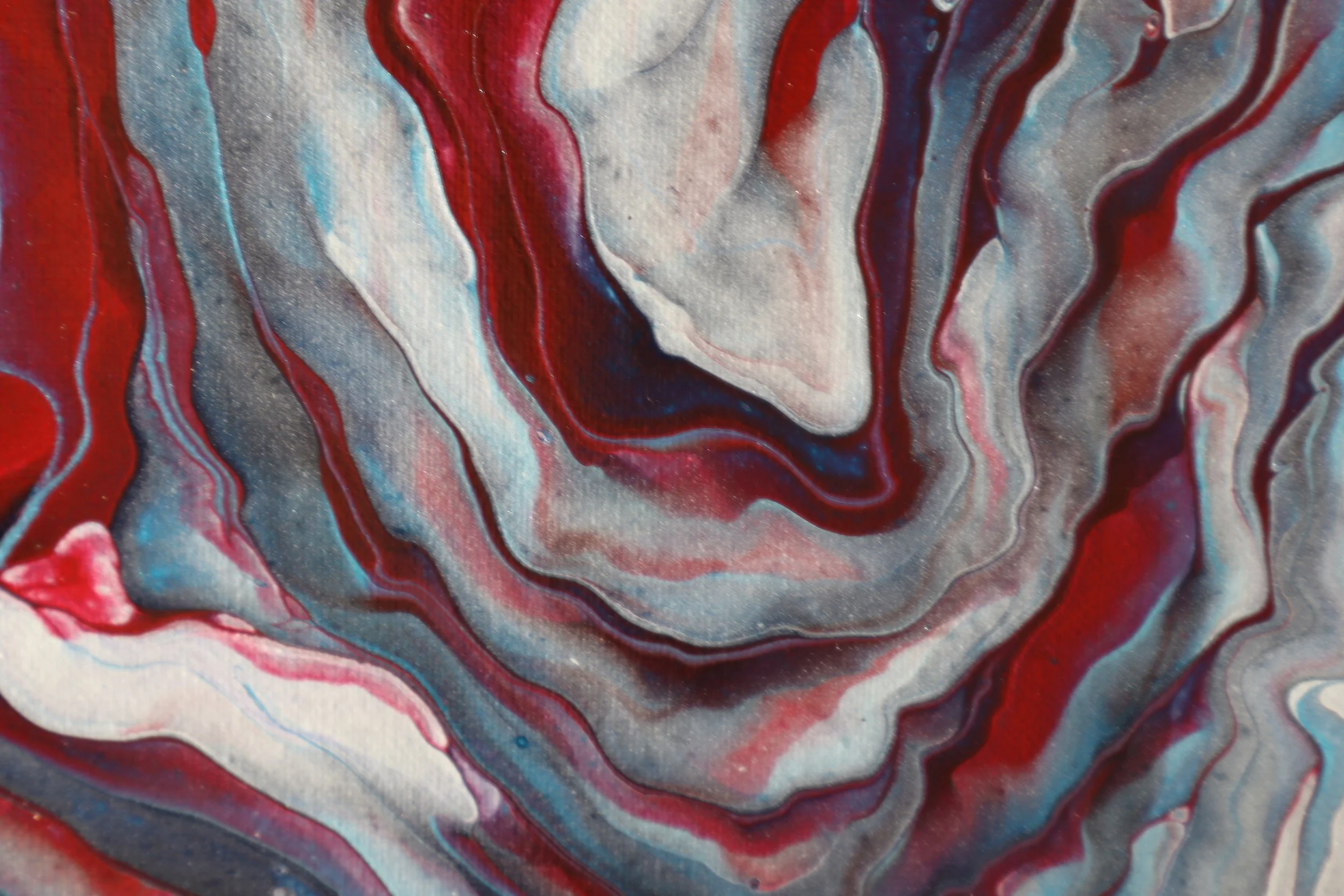 Marbled abstract painting with swirls of red, white, gray, black, and hints of blue.