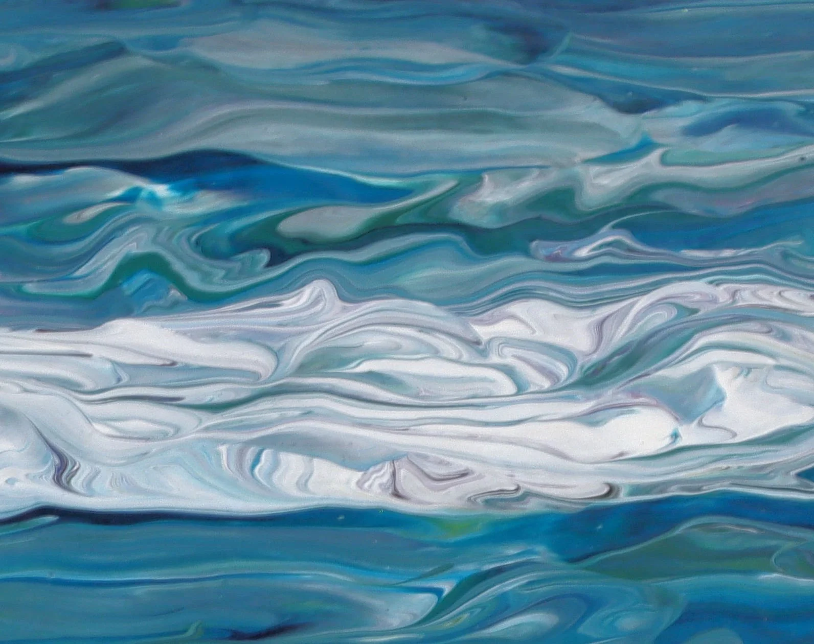 Close-up of swirling, abstract water with shades of blue, white, and hints of green.